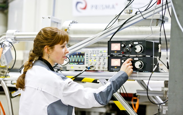 A young woman operates electronic devices